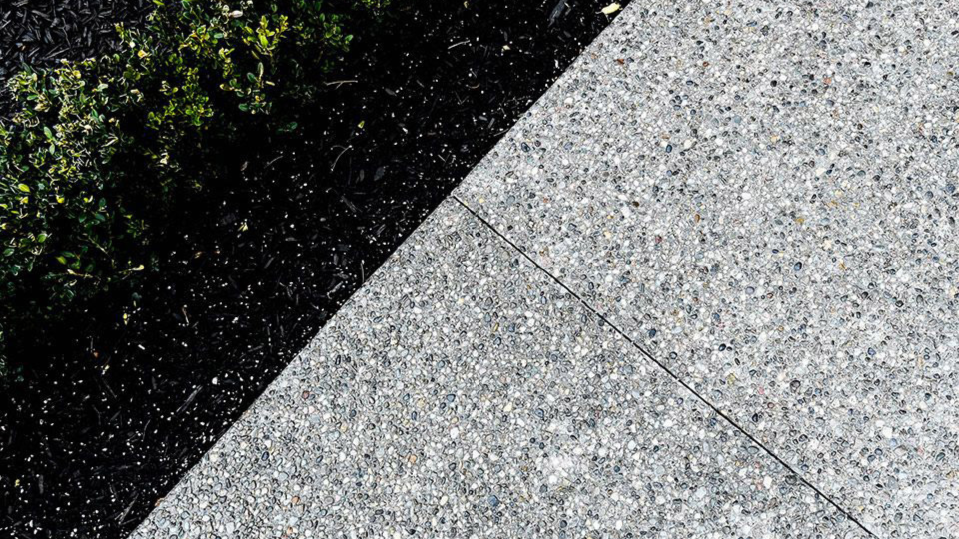 This photo shows a closeup view of a finished walkway with exposed aggregate concrete