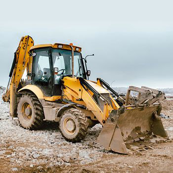 This photo shows a backhoe on a job site. 