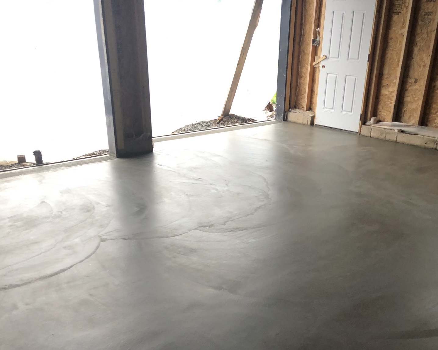 This photo shows a freshly poured concrete garage floor.
